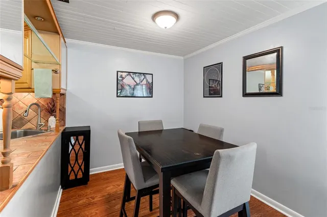 a view of a dining room with furniture and wooden floor