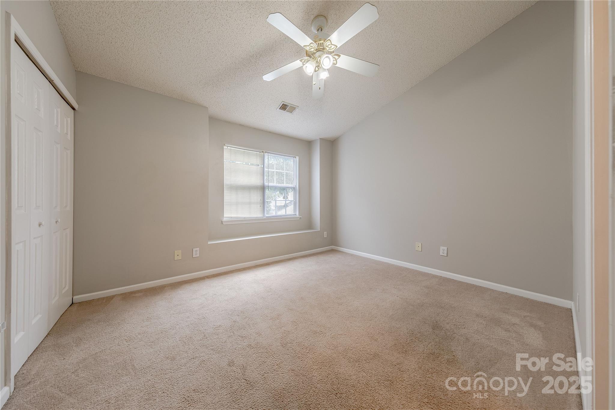 1809 Birch Heights Court Charlotte, NC 28213 - Photo 20 of 23 an empty room with windows and ceiling fan