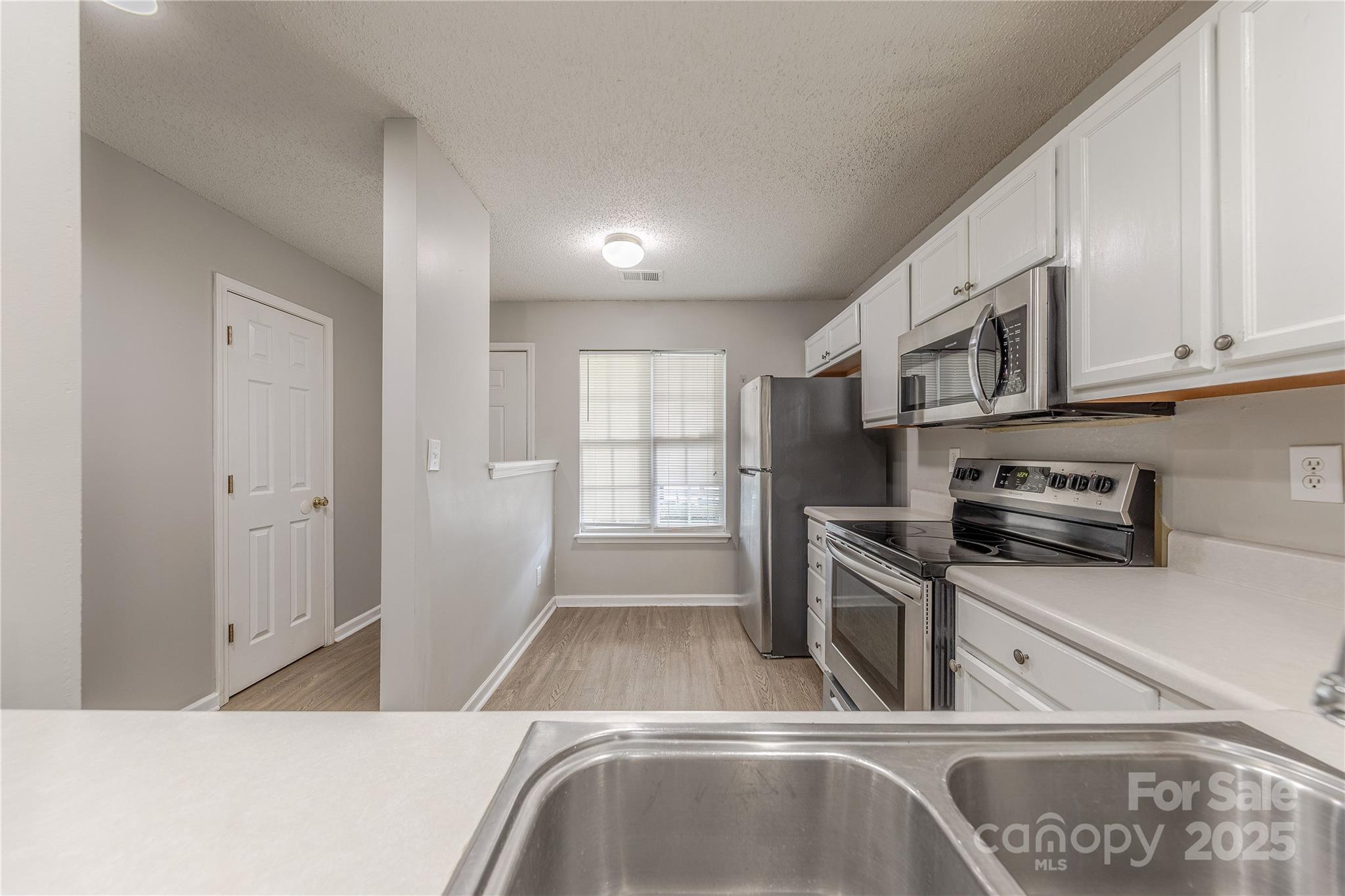 1809 Birch Heights Court Charlotte, NC 28213 - Photo 6 of 23 a kitchen with stainless steel appliances granite countertop a sink a stove and a refrigerator