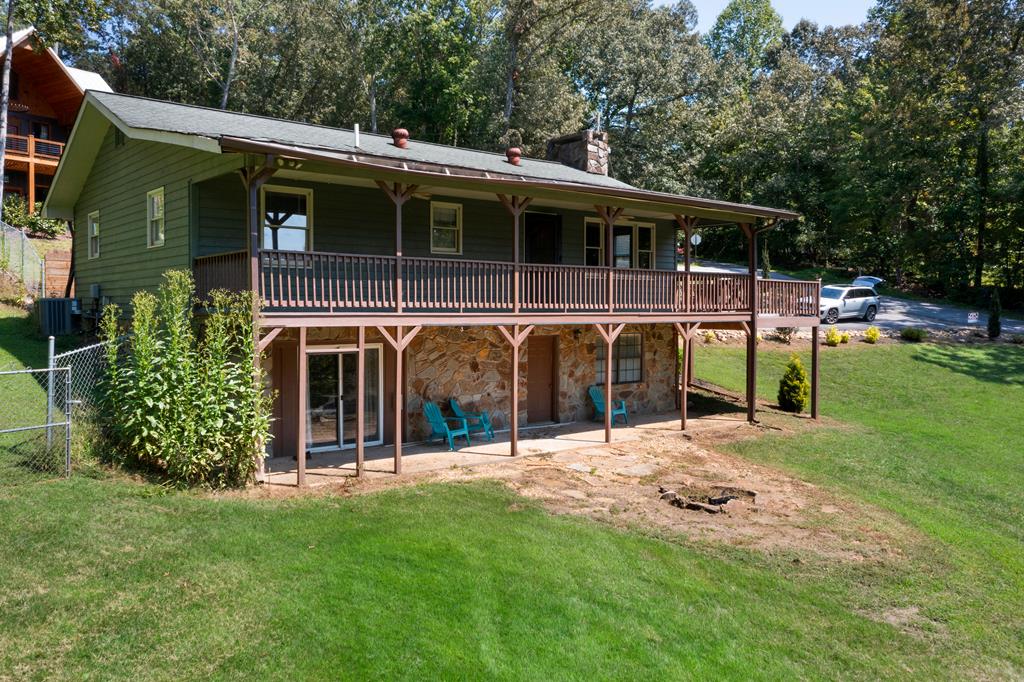 a view of an house with backyard space and balcony