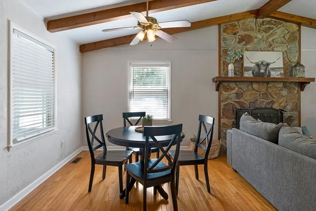 a kitchen with stainless steel appliances granite countertop a kitchen island a table and chairs