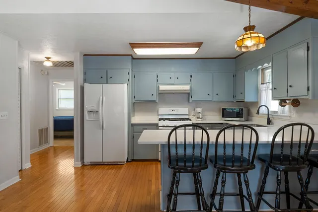 a kitchen with a sink stove top oven and cabinets
