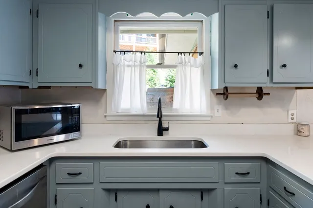 a bathroom with a sink and a window