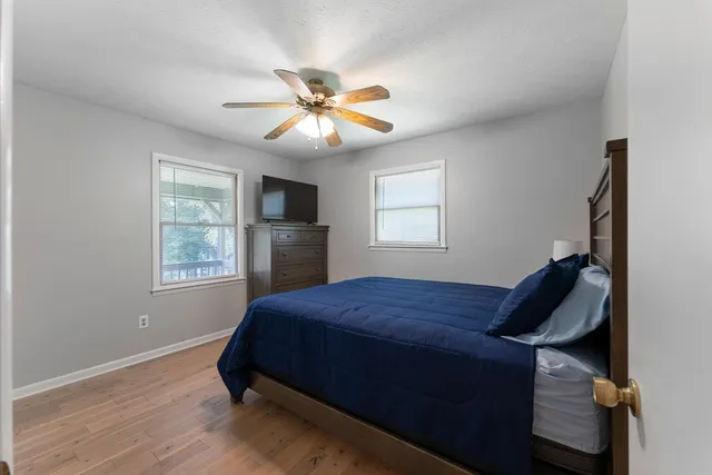 a bedroom with a bed and a chandelier