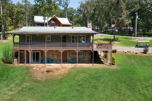 a view of a house with backyard and porch