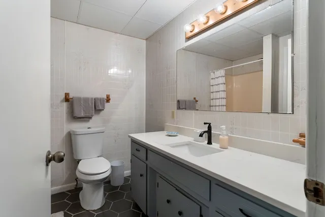 a living room with a couch and a wooden floor