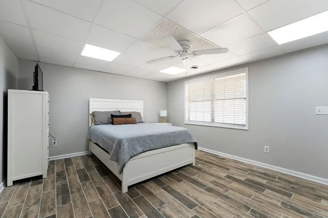 a bedroom with a bed and wooden floor