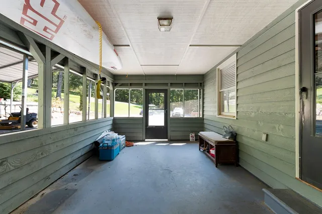a balcony with wooden floor and outdoor seating