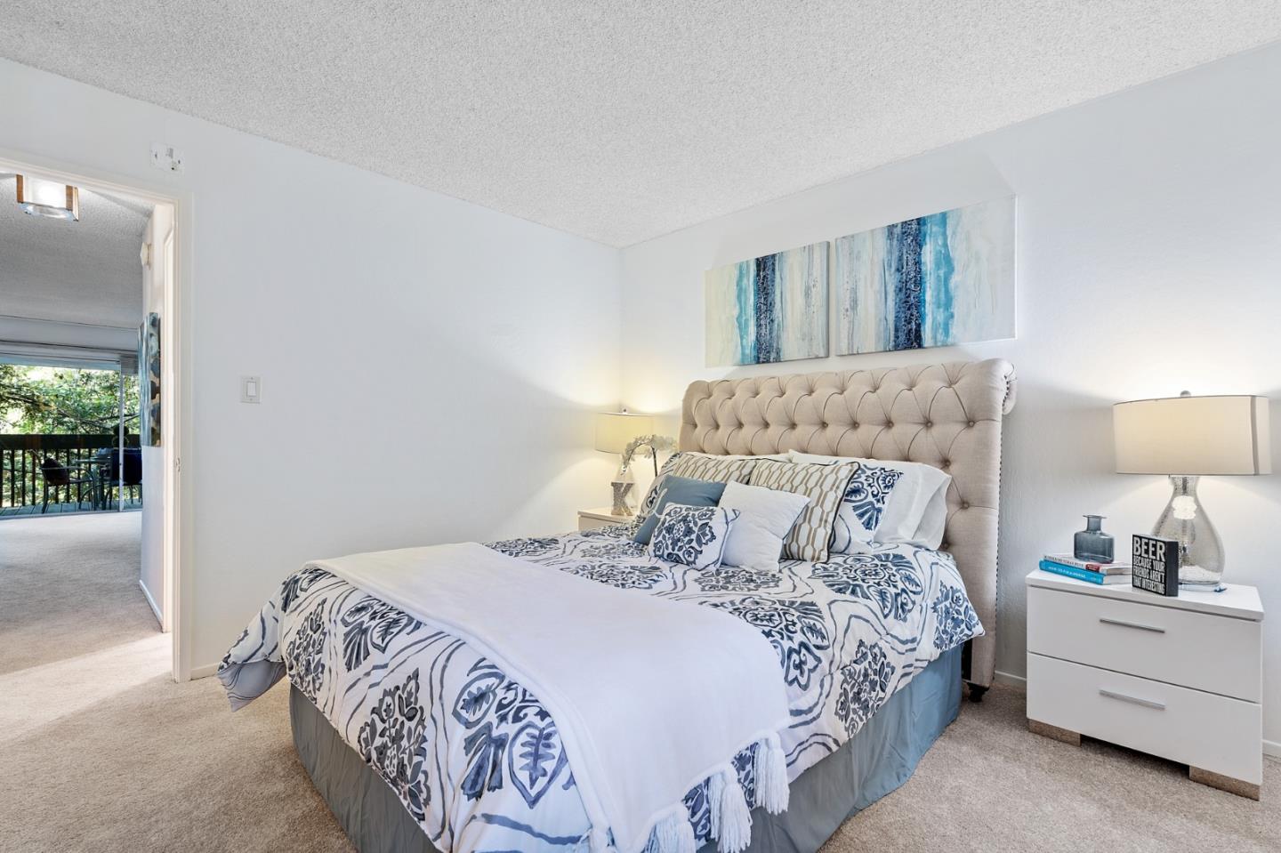 505 Cypress Point Drive, Unit 160 Mountain View, CA 94043 - Photo 11 of 20 a bedroom with a bed and a lamp