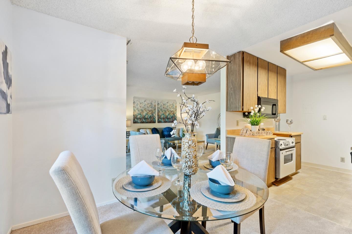 505 Cypress Point Drive, Unit 160 Mountain View, CA 94043 - Photo 5 of 20 a living room with furniture and a table