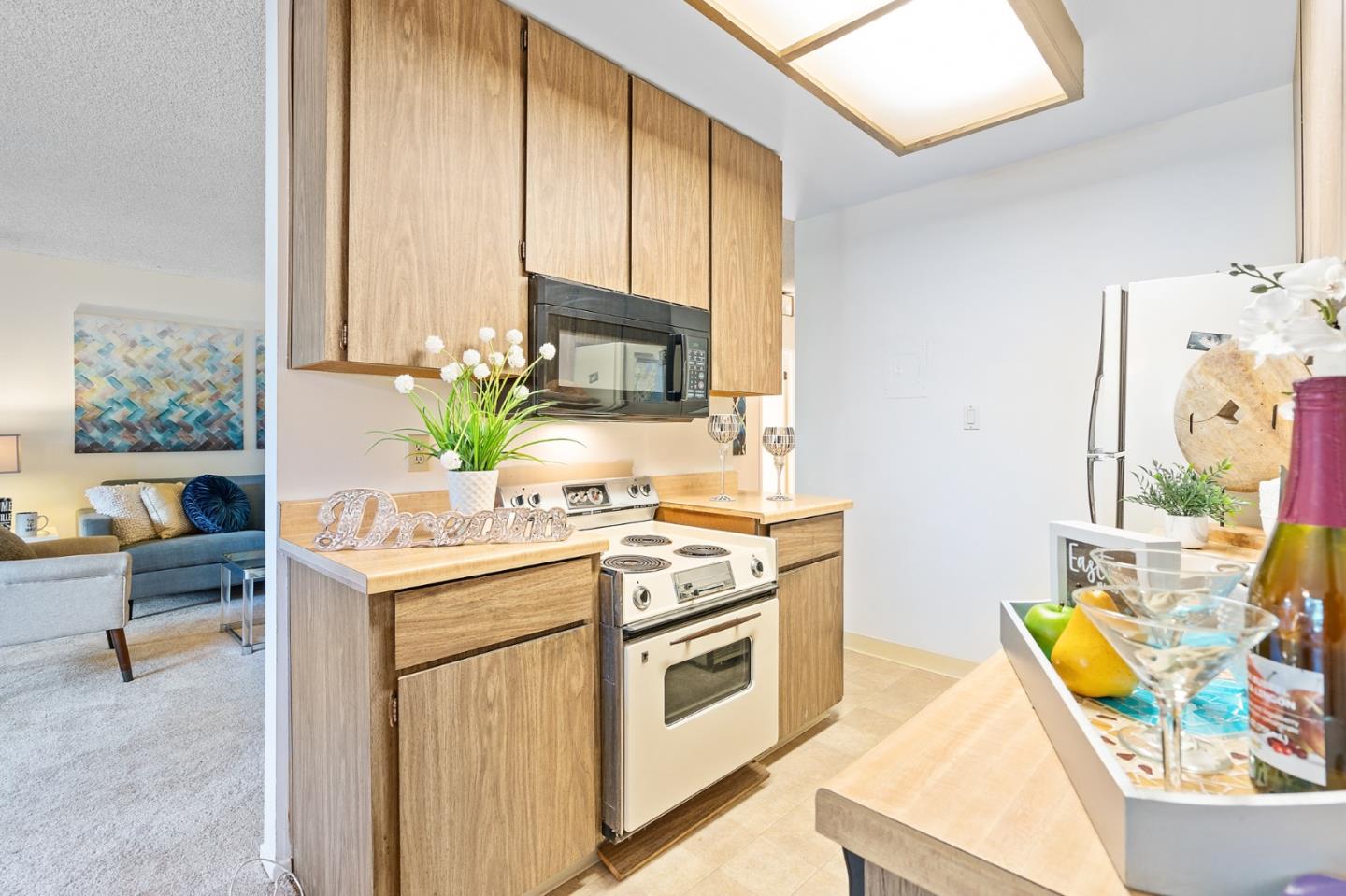 505 Cypress Point Drive, Unit 160 Mountain View, CA 94043 - Photo 6 of 20 a kitchen with stainless steel appliances granite countertop a stove a sink and a microwave