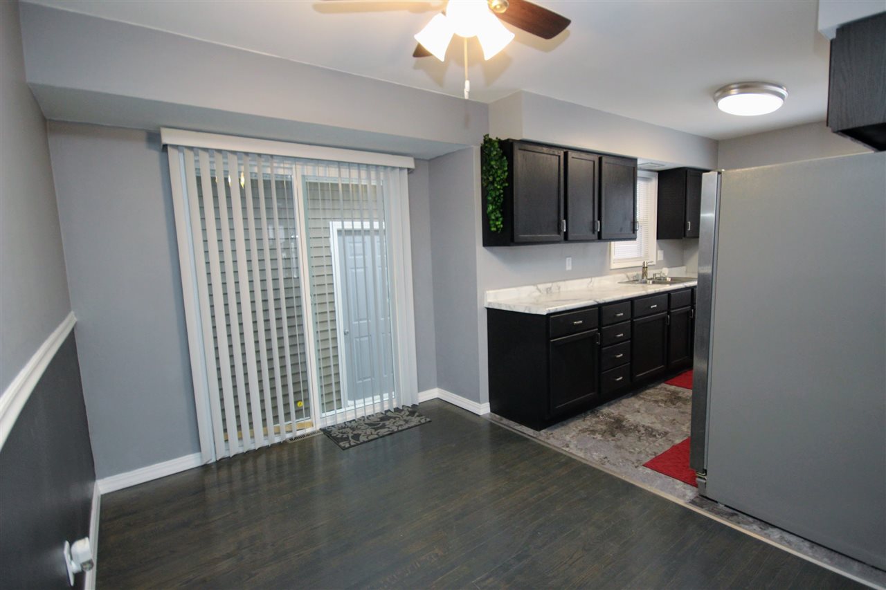 6101 Park Ridge Road Loves Park, IL 61111 - Photo 5 of 21 an empty room with a kitchen and a window