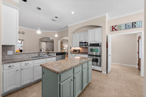 a view of a dining room with furniture and a potted plant