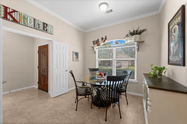 a view of a dining room with furniture a chandelier and wooden floor