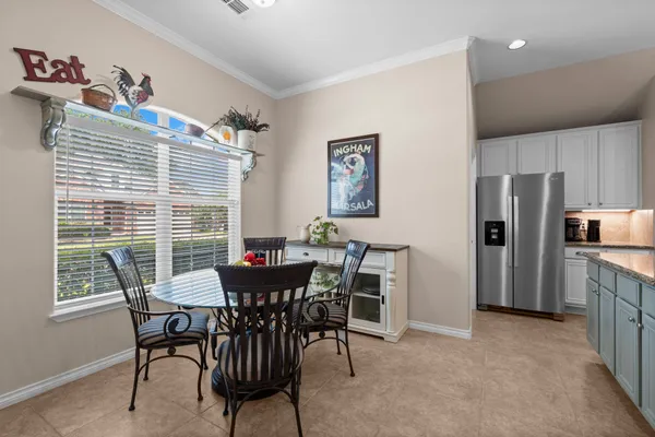 a view of a dining room and livingroom with furniture wooden floor a chandelier