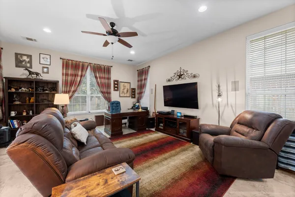 a living room with furniture a dining table and a piano