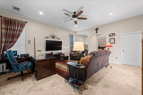 a bedroom with a bed a dresser next to a window