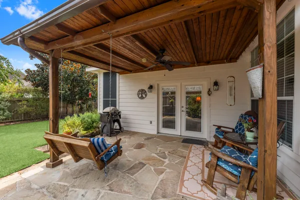 a view of a porch with furniture and floor to ceiling window