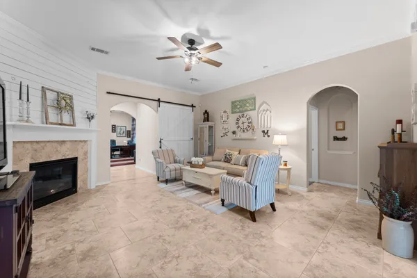 a living room with furniture a fireplace and a flat screen tv