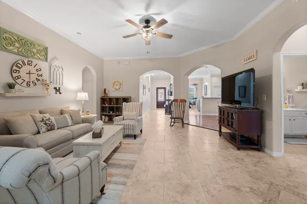 a living room with furniture a flat screen tv and a fireplace
