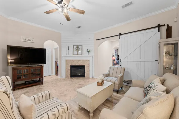 a living room with furniture and a chandelier