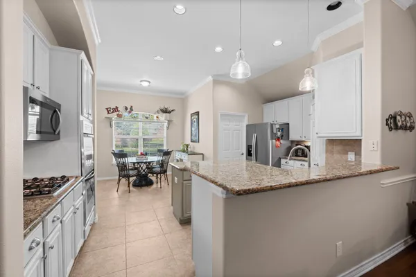 a view of a dining room with furniture and chandelier