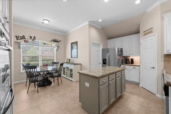 a kitchen with refrigerator cabinets and microwave