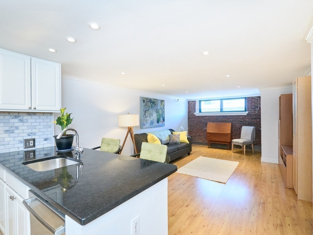 42 8th Street, Unit 5521 Boston, MA 02129 - Photo 1 of 25 a kitchen with granite countertop a sink and a counter top space