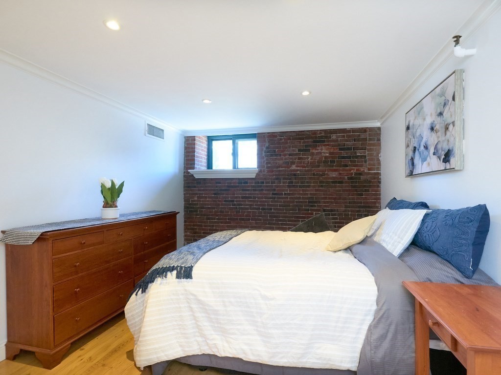 42 8th Street, Unit 5521 Boston, MA 02129 - Photo 11 of 25 a bed sitting in a bedroom and chair