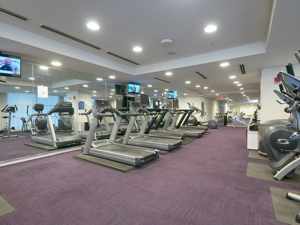 42 8th Street, Unit 5521 Boston, MA 02129 - Photo 18 of 25 a view of a room with gym equipment and a large mirror