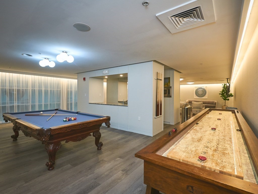 42 8th Street, Unit 5521 Boston, MA 02129 - Photo 20 of 25 a living room with pool table and windows