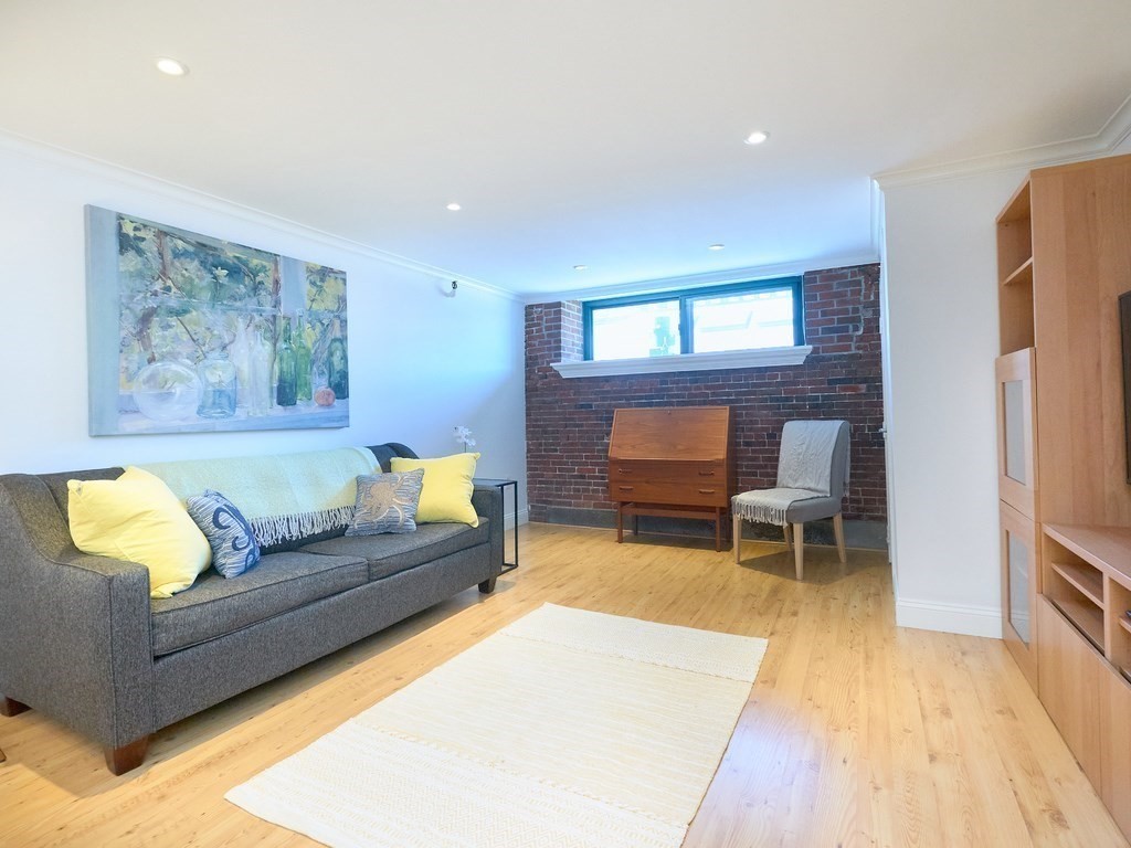 42 8th Street, Unit 5521 Boston, MA 02129 - Photo 2 of 25 a living room with furniture and a wooden floor