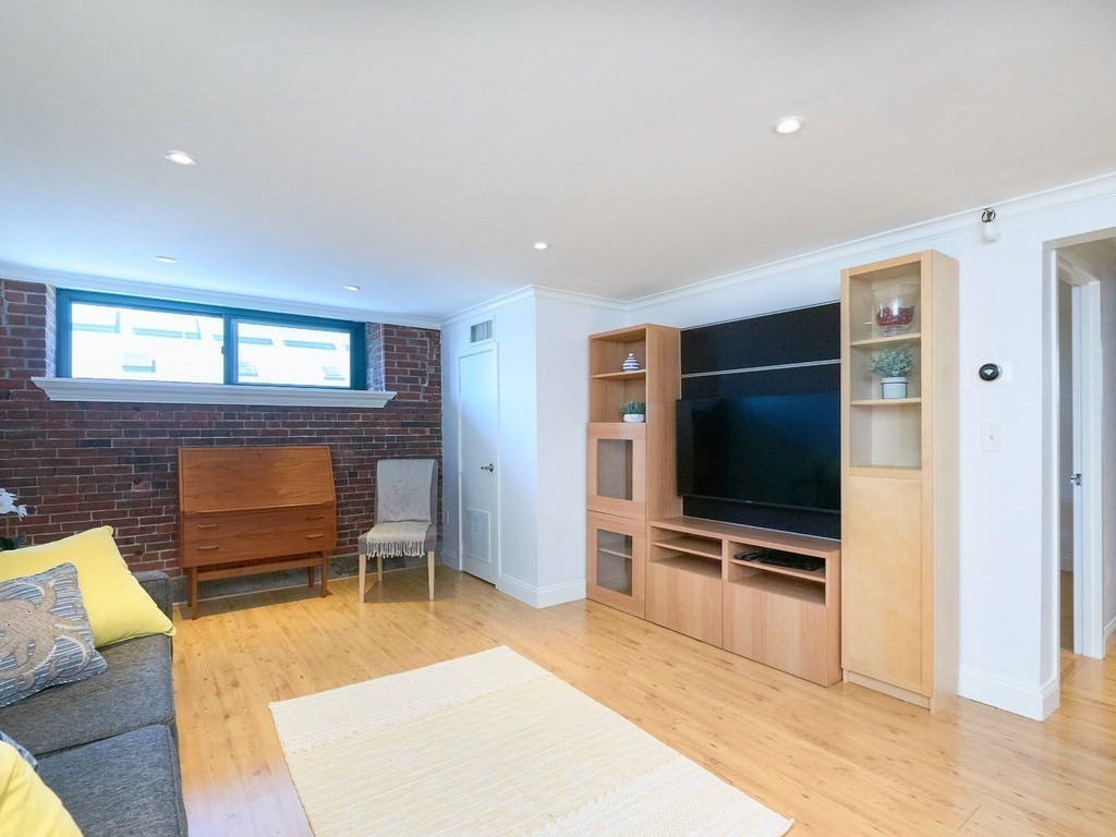42 8th Street, Unit 5521 Boston, MA 02129 - Photo 3 of 25 a living room with furniture and a flat screen tv