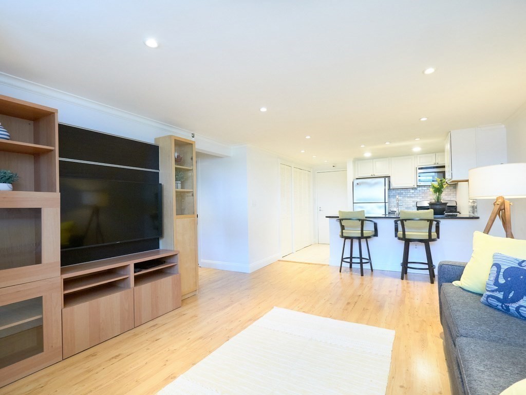 42 8th Street, Unit 5521 Boston, MA 02129 - Photo 4 of 25 a living room with furniture and a flat screen tv