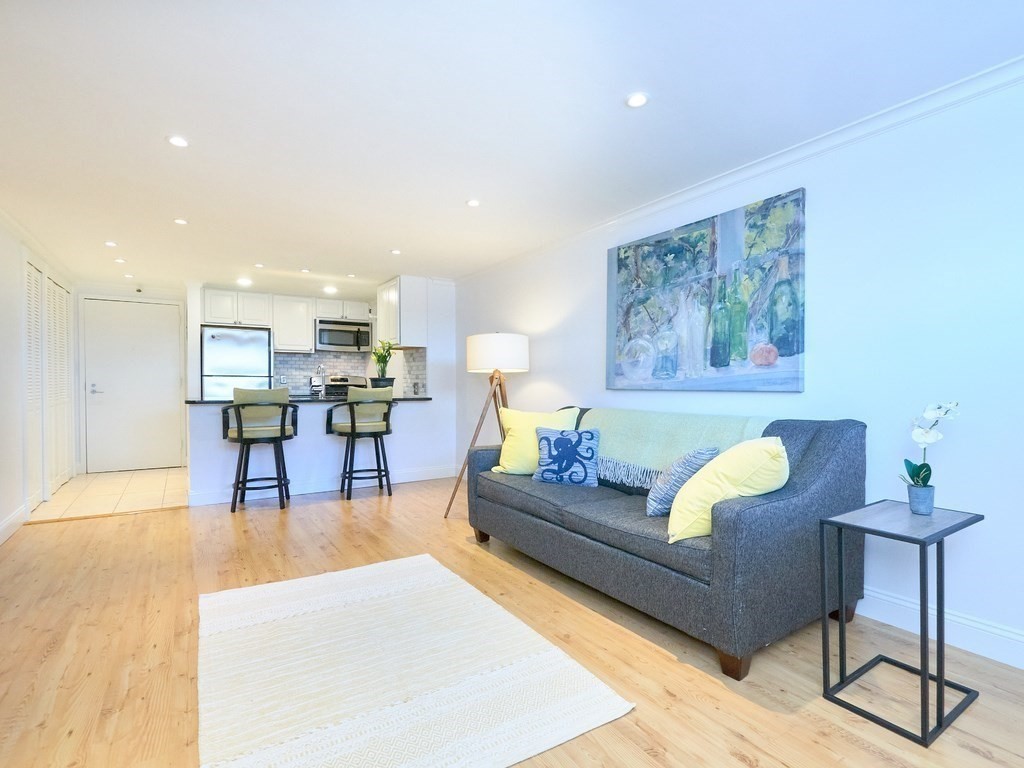 42 8th Street, Unit 5521 Boston, MA 02129 - Photo 5 of 25 a living room with furniture and kitchen view