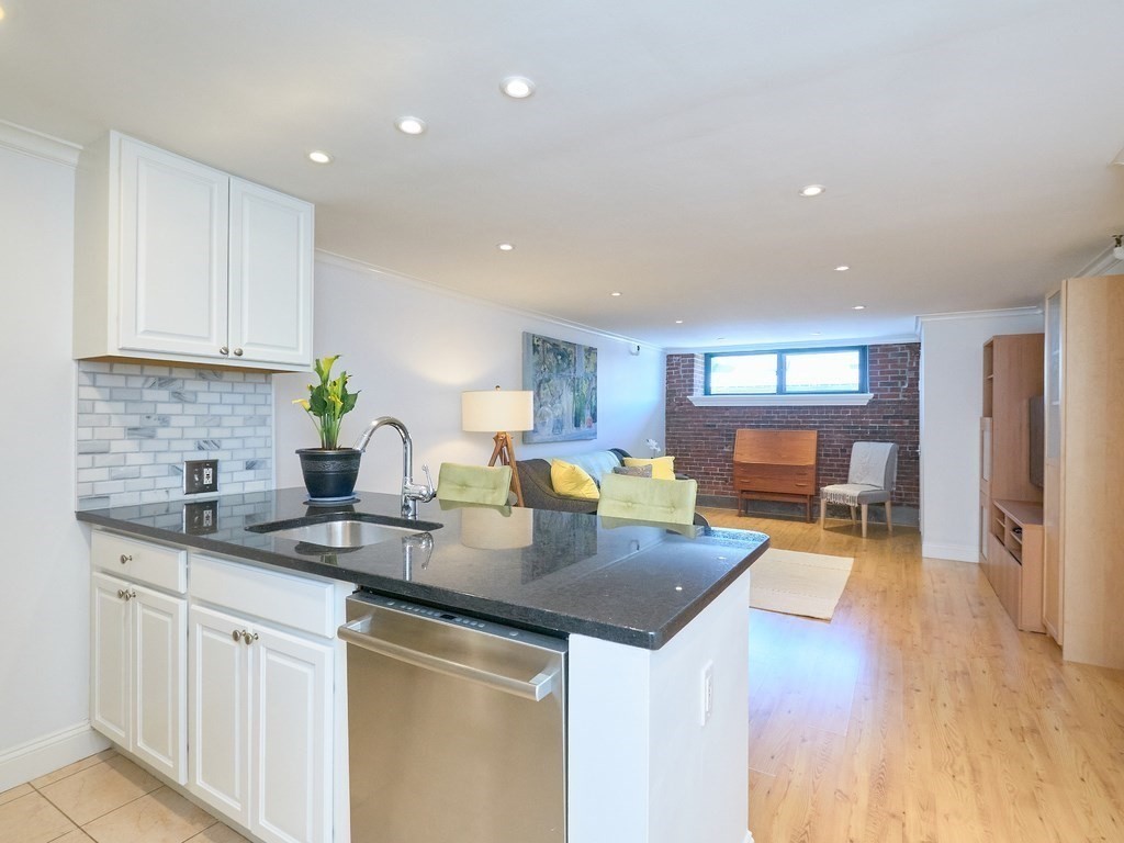 42 8th Street, Unit 5521 Boston, MA 02129 - Photo 7 of 25 a kitchen with a sink a stove cabinets and counter space