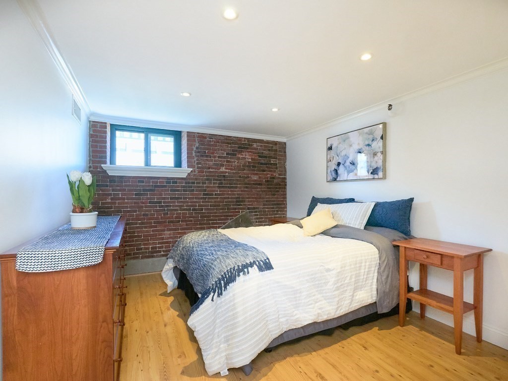 42 8th Street, Unit 5521 Boston, MA 02129 - Photo 10 of 25 a bedroom with a bed and a dresser