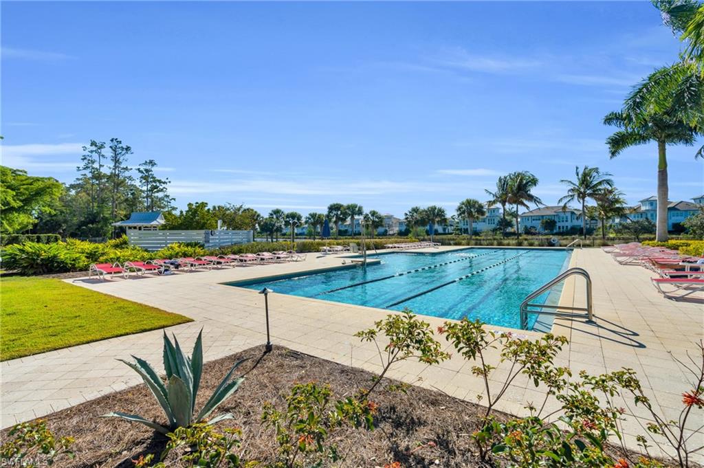 8937 Calypso Court Naples, FL 34113 - Photo 31 of 43 a view of a swimming pool and a yard