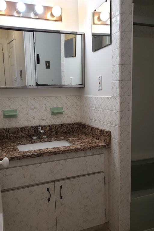 924 Beacon Street, Unit 6 Boston, MA 02215 - Photo 17 of 28 a view of a storage and utility room with washer and dryer