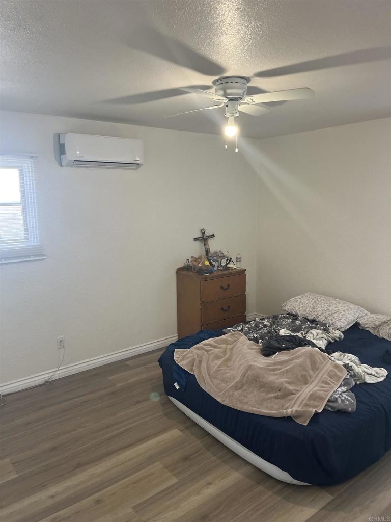 1280 Manor Drive El Cajon, CA 92021 - Photo 7 of 11 a bedroom with a bed and a ceiling fan