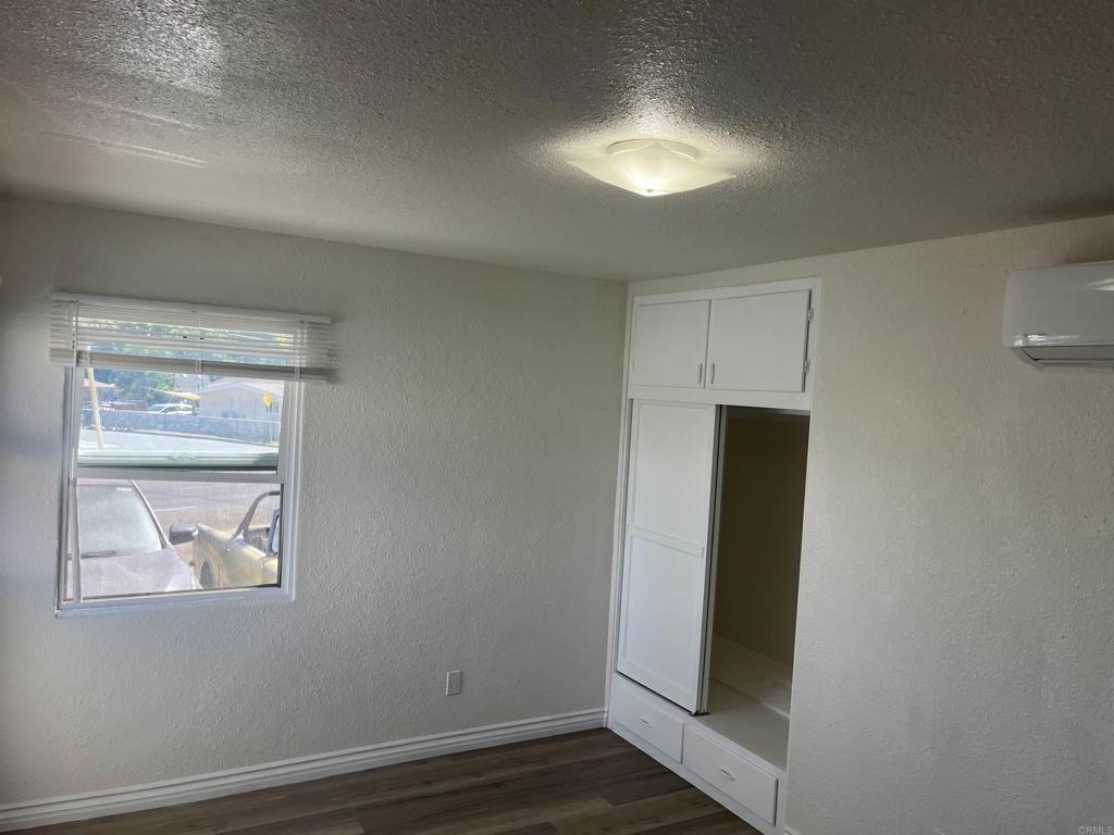 1280 Manor Drive El Cajon, CA 92021 - Photo 10 of 11 an empty room with wooden floor and closet