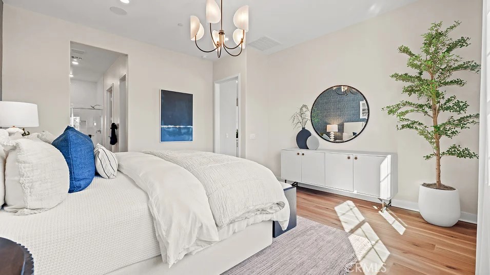 211 Bounty Road Rancho Mission Viejo, CA 92694 - Photo 11 of 28 a bedroom with bed and a chandelier