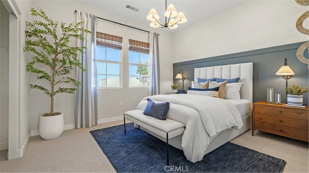 211 Bounty Road Rancho Mission Viejo, CA 92694 - Photo 15 of 28 a bedroom with a large bed and a chandelier