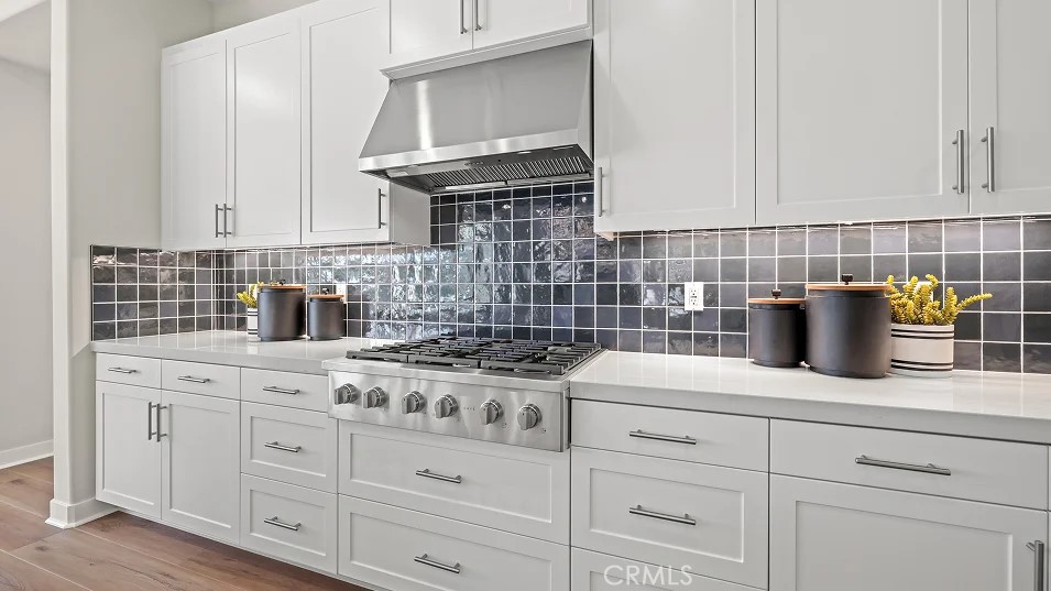 211 Bounty Road Rancho Mission Viejo, CA 92694 - Photo 2 of 28 a kitchen with white cabinets and appliances