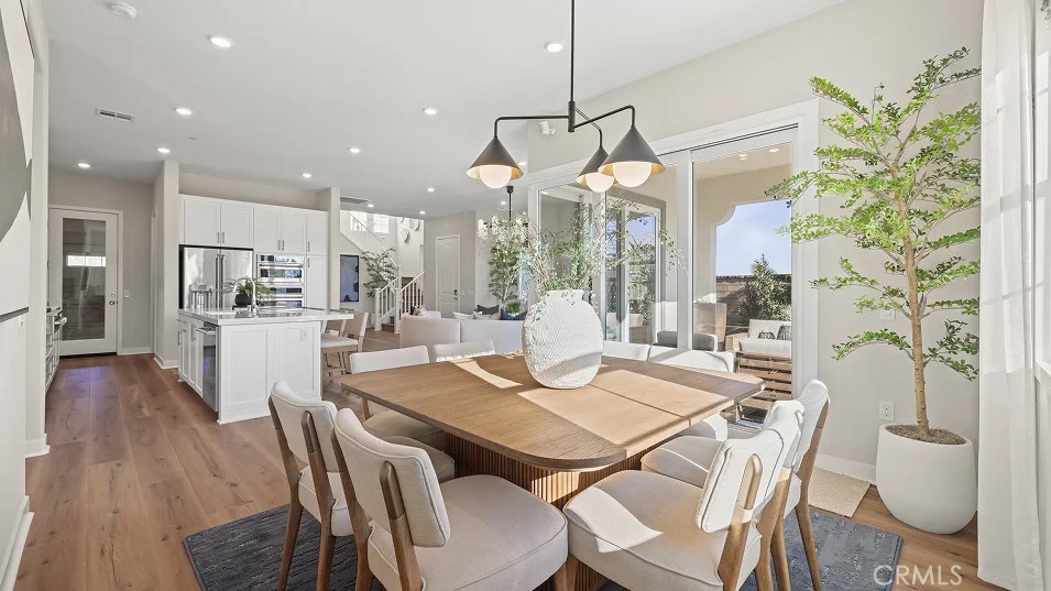 211 Bounty Road Rancho Mission Viejo, CA 92694 - Photo 6 of 28 a view of a dining room and livingroom with furniture wooden floor a chandelier
