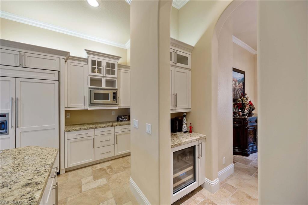 23801 Napoli Way Estero, FL 34134 - Photo 18 of 50 a kitchen with cabinets and a stove top oven