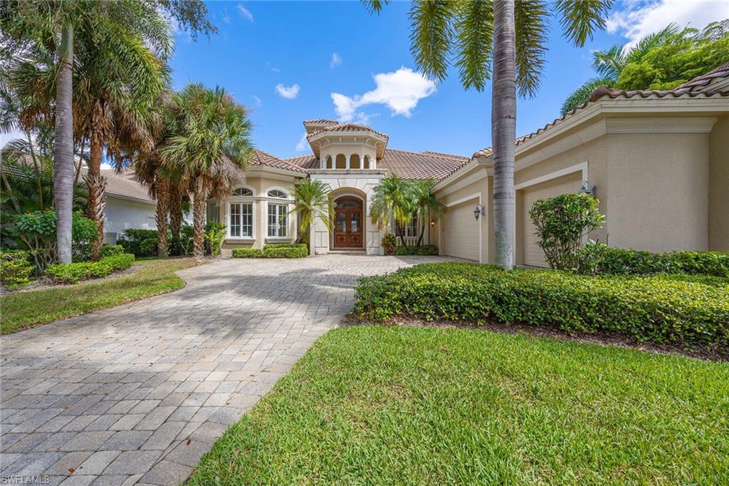 23801 Napoli Way Estero, FL 34134 - Photo 2 of 50 a front view of a house with garden and trees