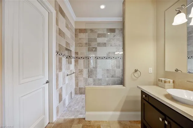 a bathroom with a granite countertop bathtub shower sink and vanity