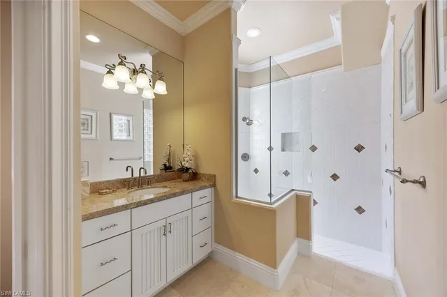 a spacious bathroom with a granite countertop sink a mirror a bathtub and a shower