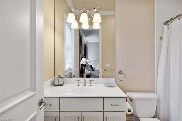 a bathroom with a sink and a mirror with window